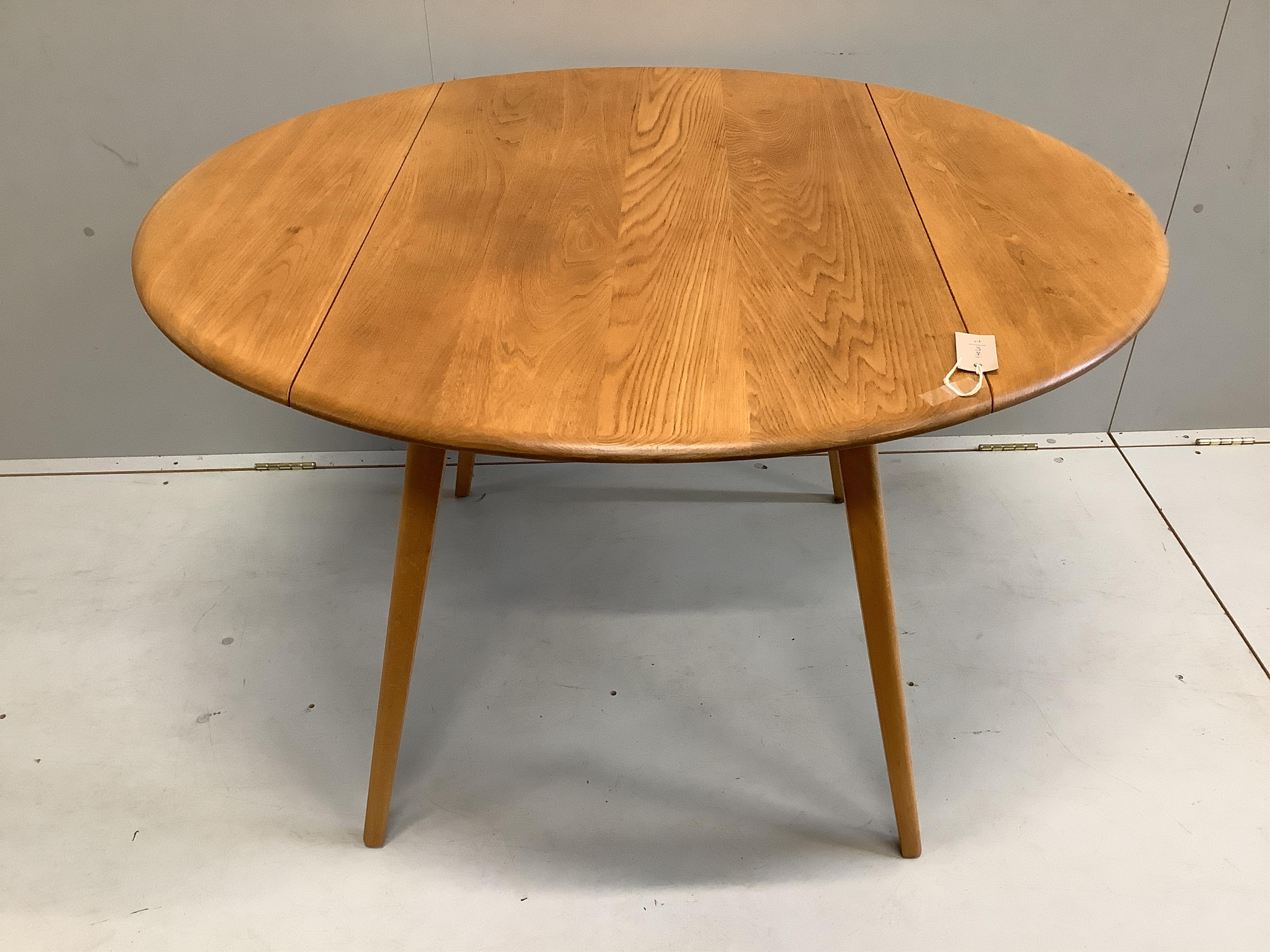 An Ercol elm drop leaf dining table, width 102cm, depth 64cm, height 71cm